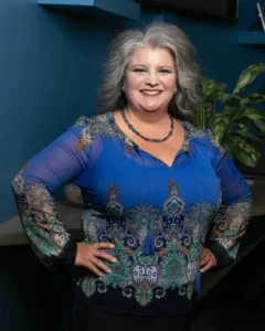 Professional woman in a real estate office with Tucson landmarks in the background